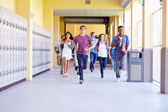 group high school students running corridor towards camera smiling 41525110